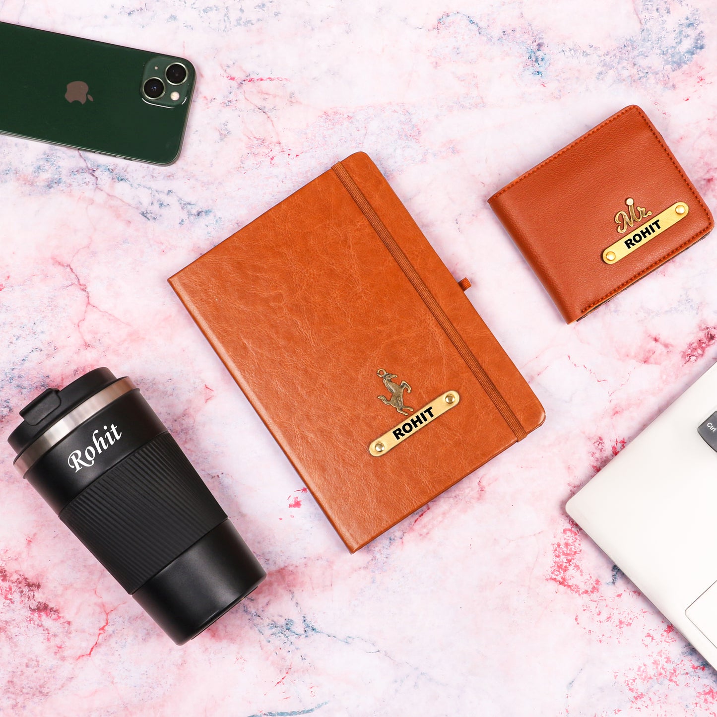 Black tumbler with tan diary and wallet