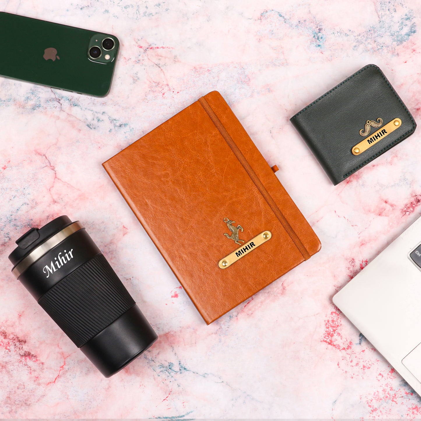 Black tumbler with tan diary and black wallet