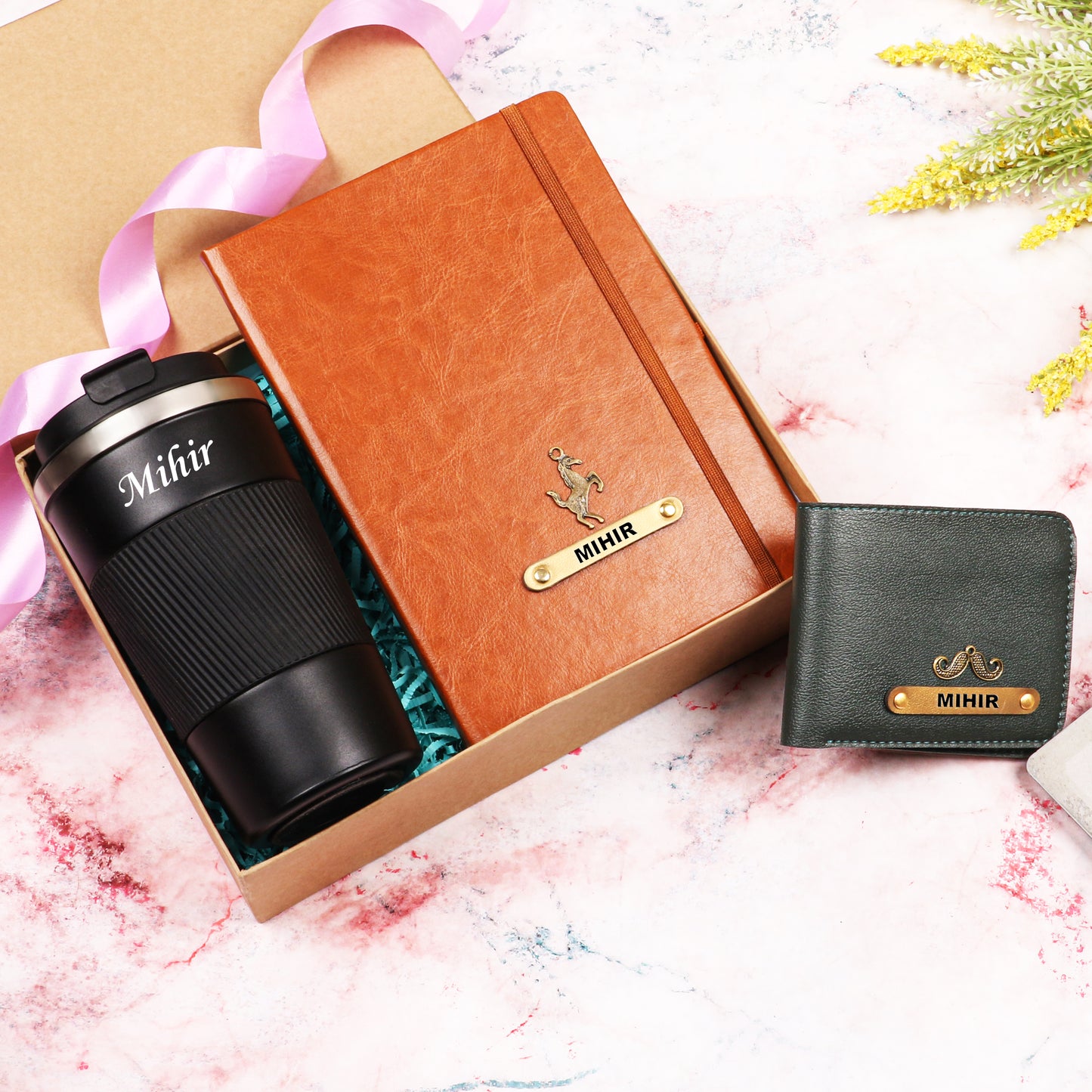 Black tumbler with tan diary and black wallet