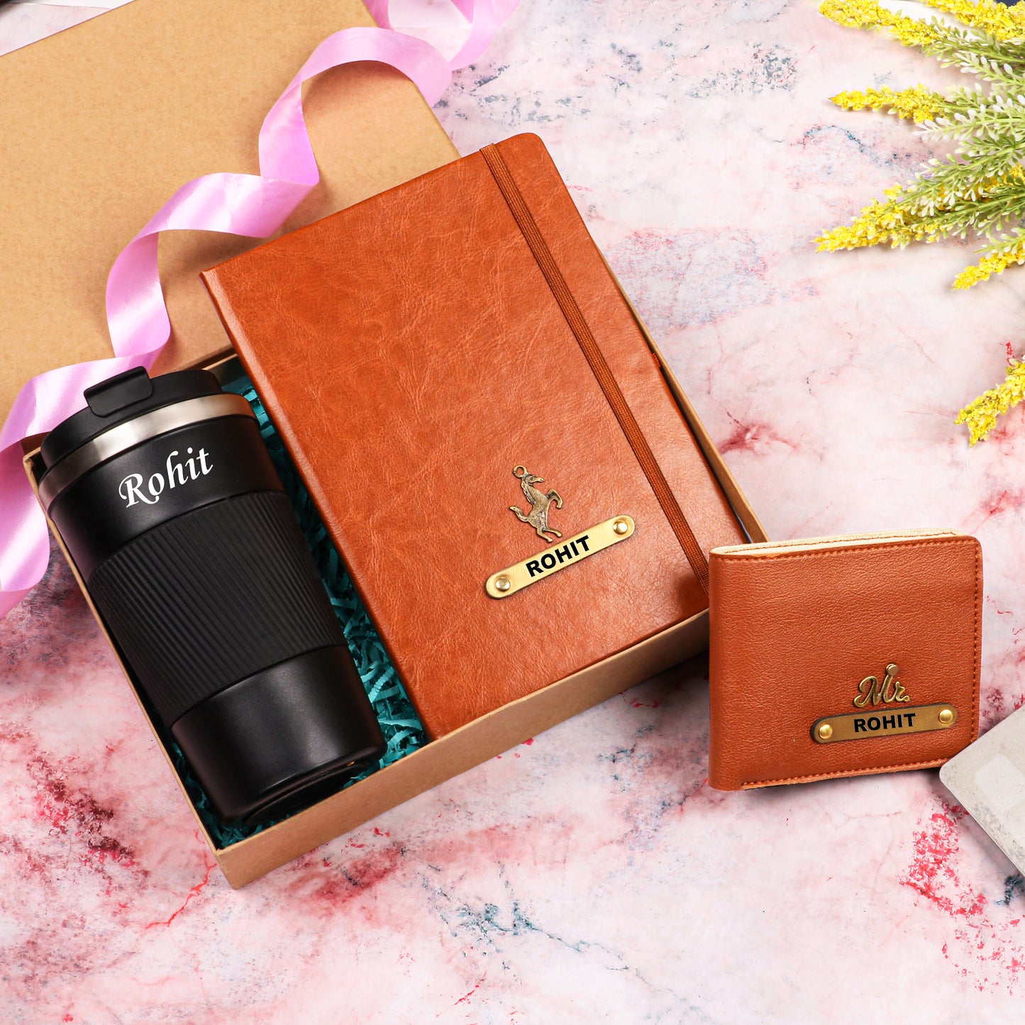 Black tumbler with tan diary and wallet
