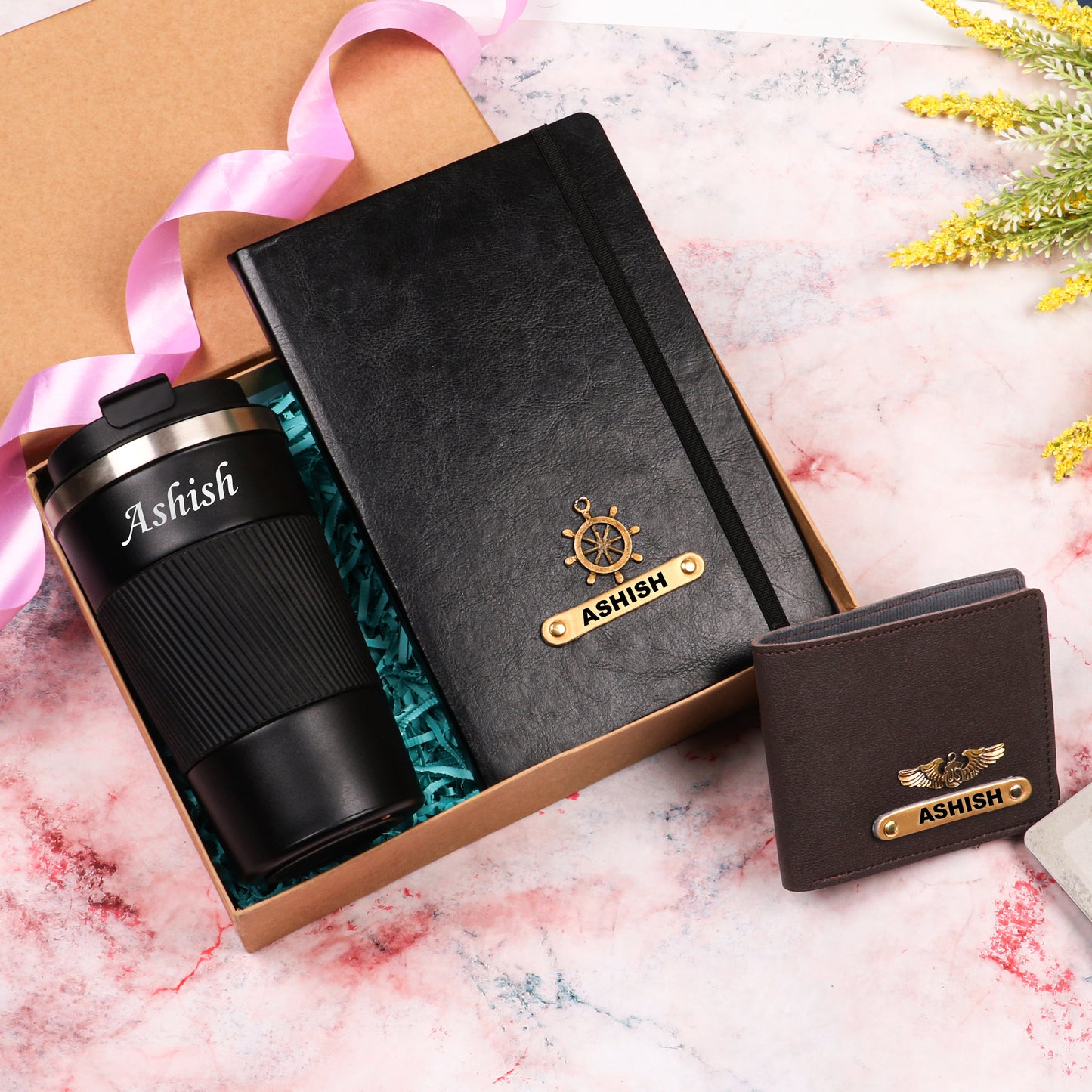 Black diary with tumbler and brown wallet