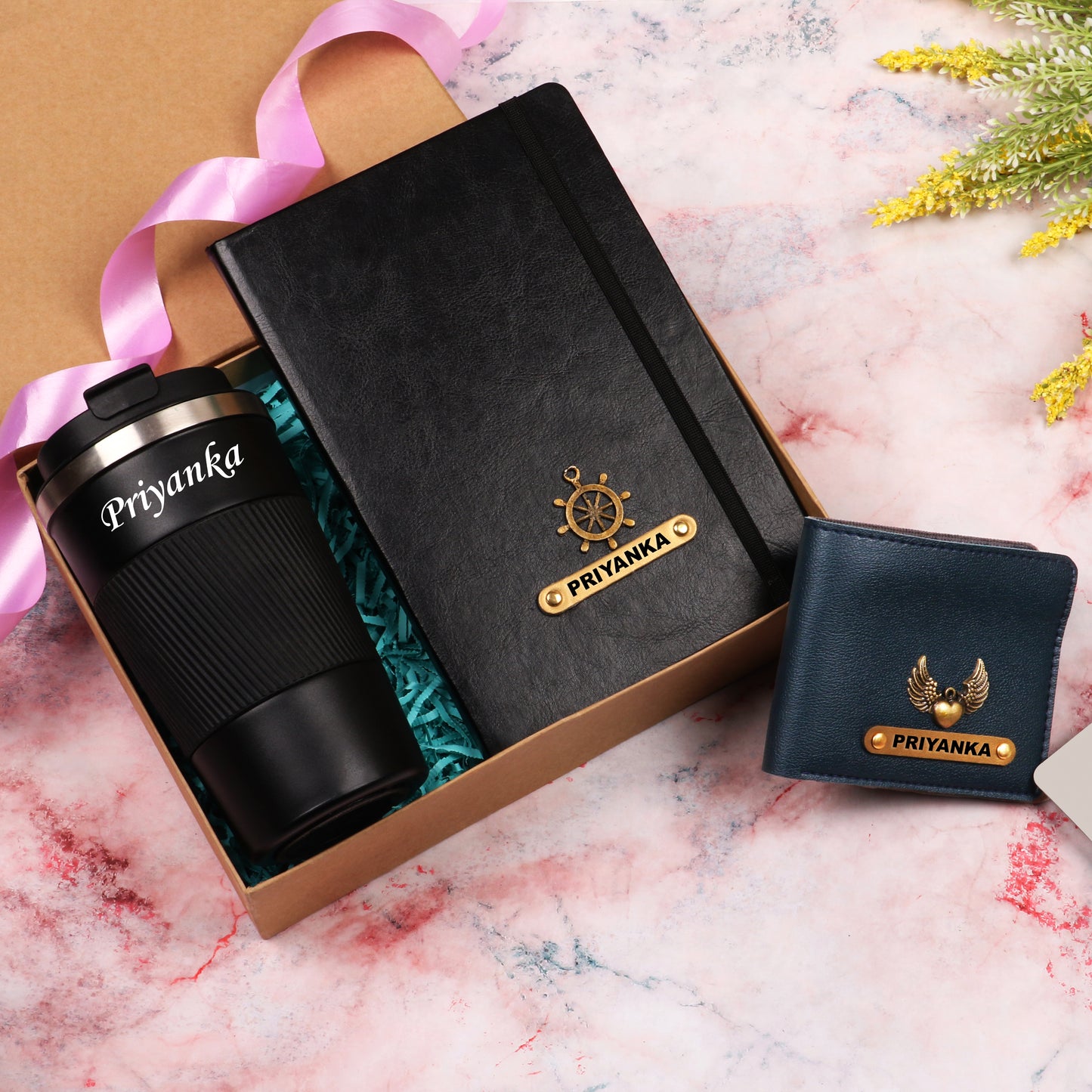 Black diary with tumbler and dark blue wallet