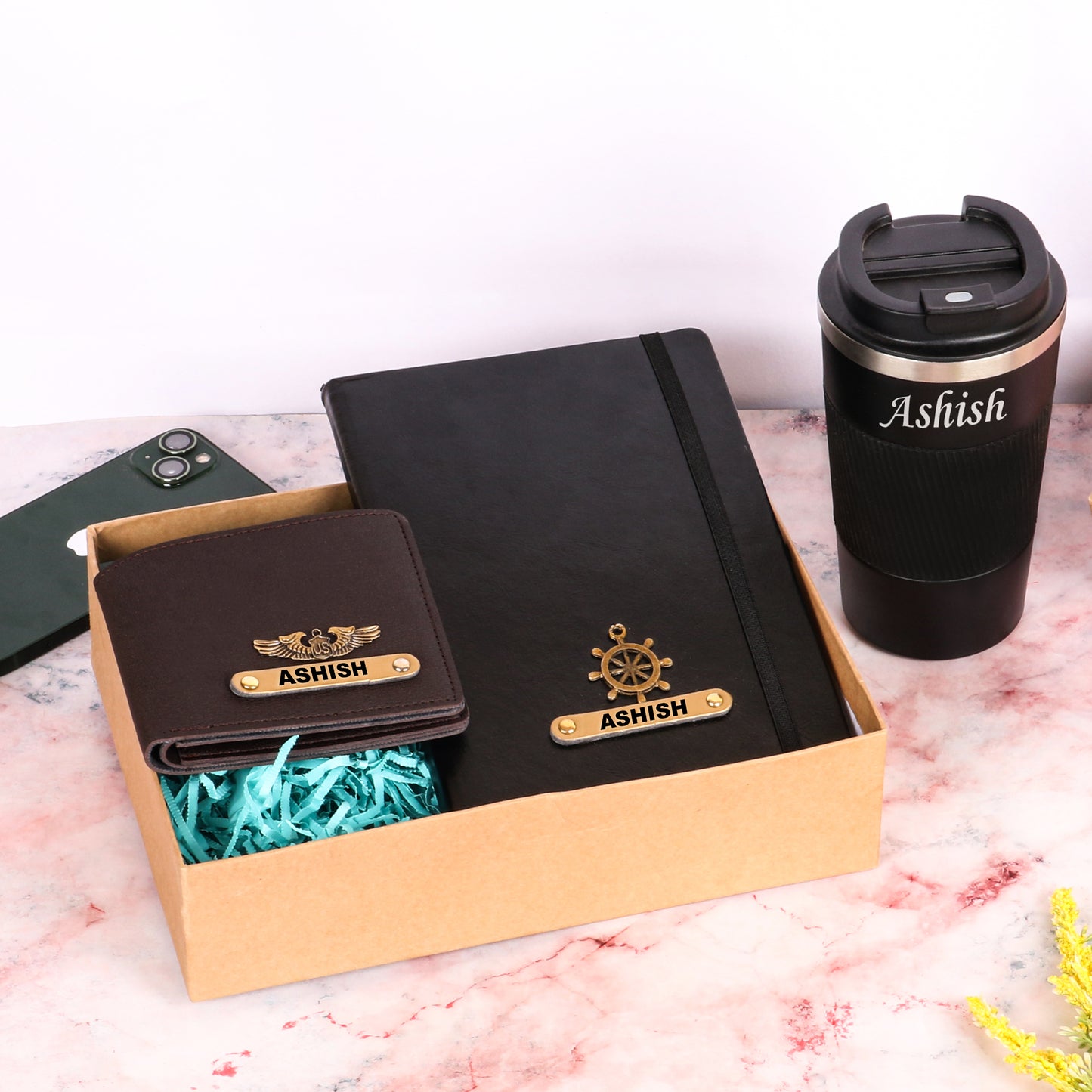 Black diary with tumbler and brown wallet