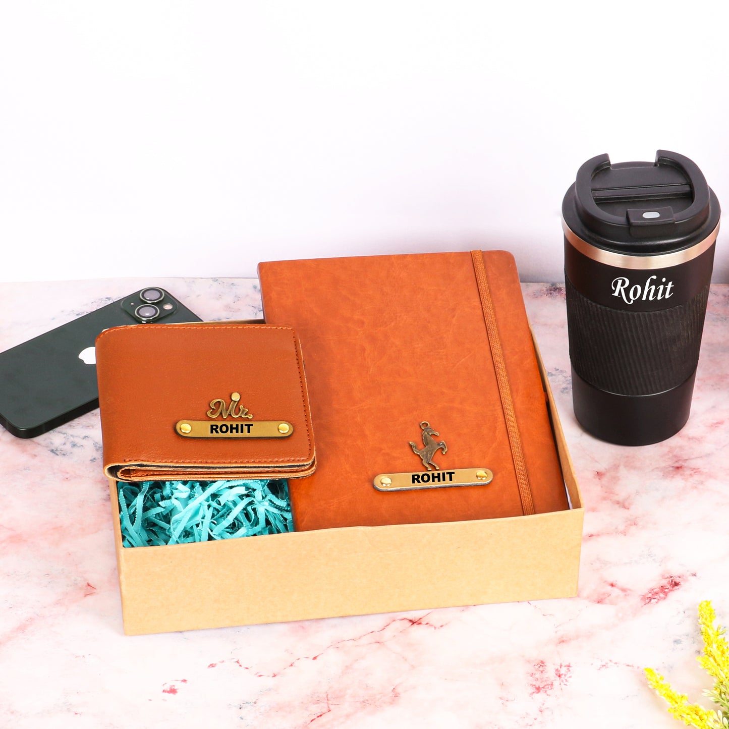 Black tumbler with tan diary and wallet