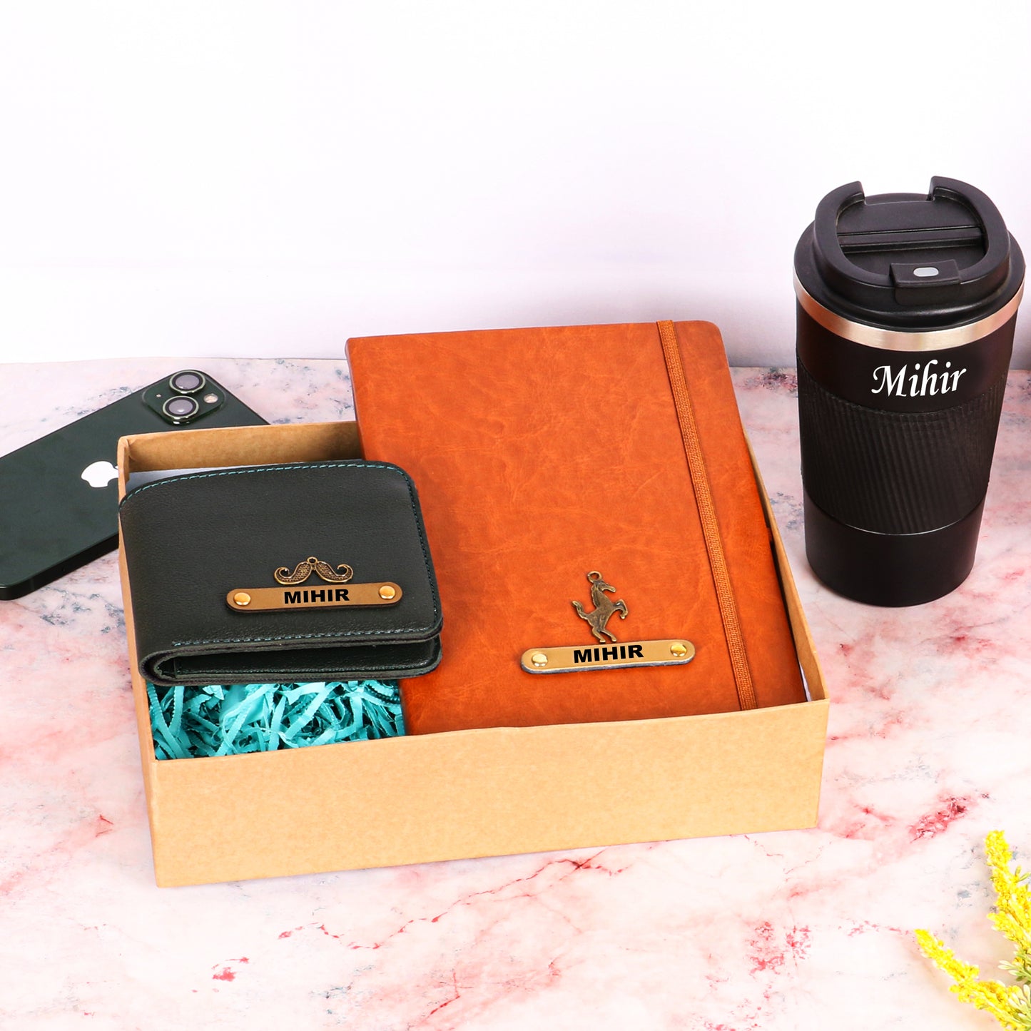 Black tumbler with tan diary and black wallet