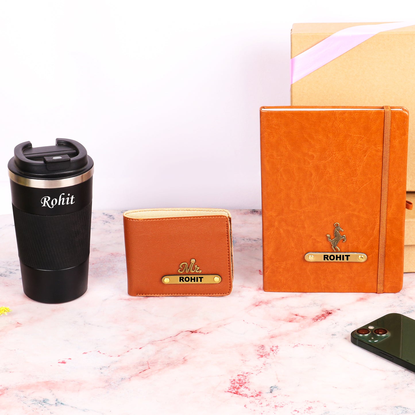Black tumbler with tan diary and wallet