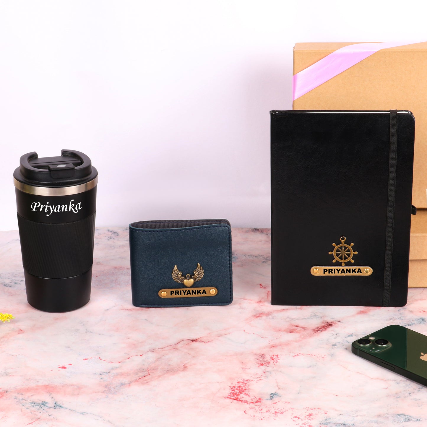 Black diary with tumbler and dark blue wallet