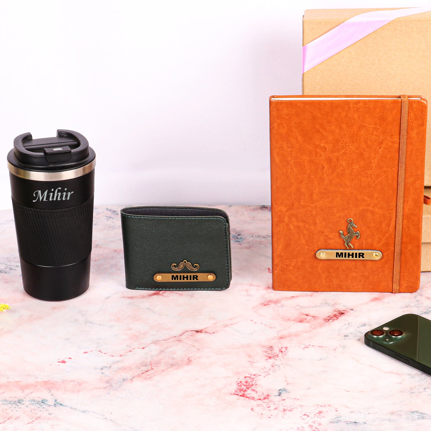 Black tumbler with tan diary and black wallet