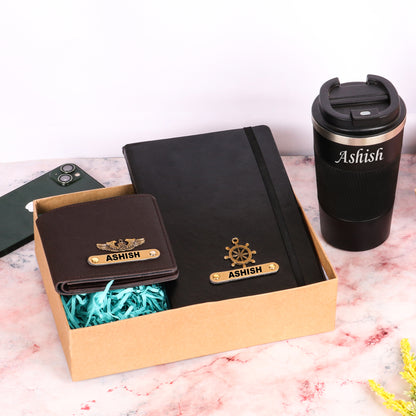 Black diary with tumbler and brown wallet