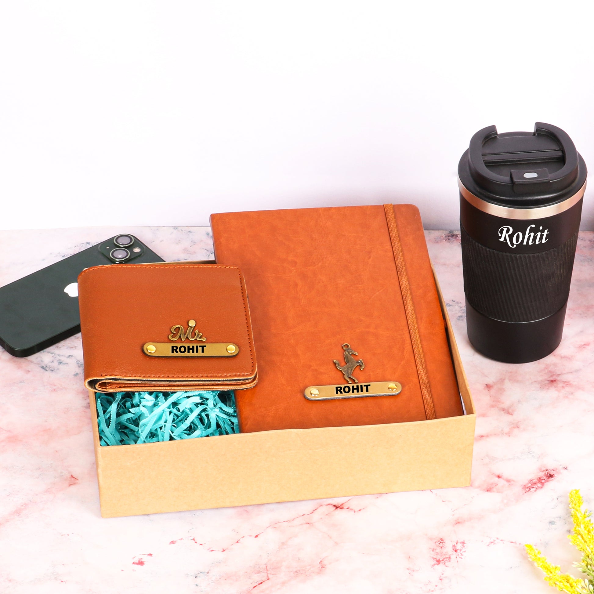 Black tumbler with tan diary and wallet