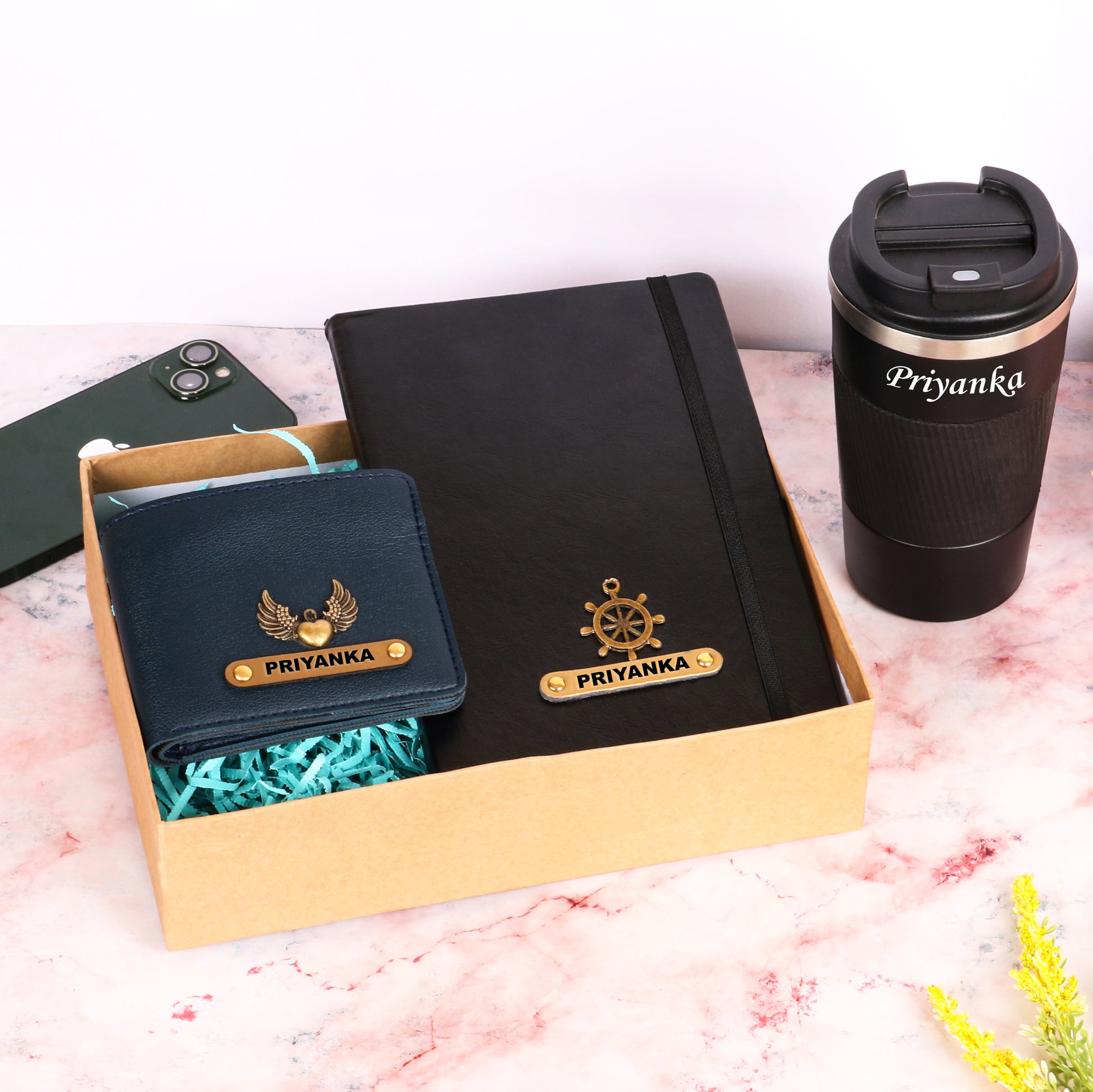 Black diary with tumbler and dark blue wallet